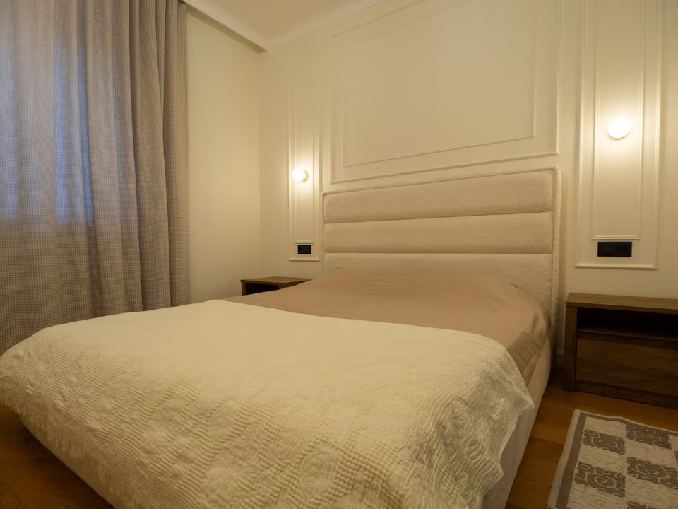 A bright bedroom in the example apartment